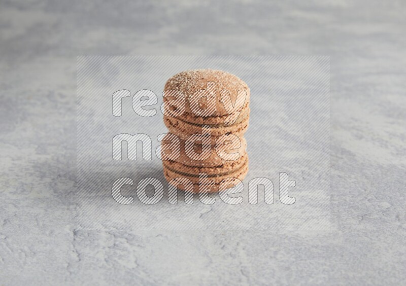 45º Shot of two Brown Hazelnuts macarons  on white  marble background