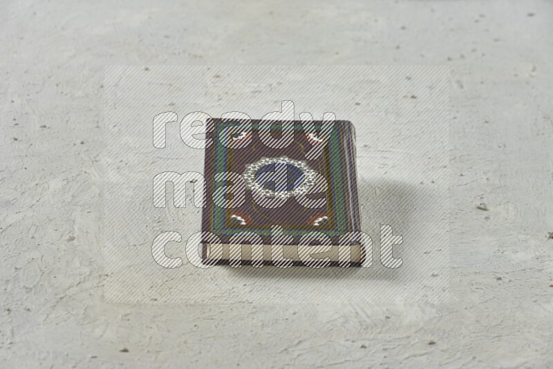 Quran with a prayer beads on white background