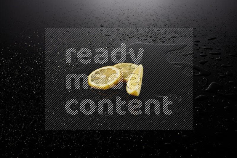 Lemon slices with water drops, and droplets on black background