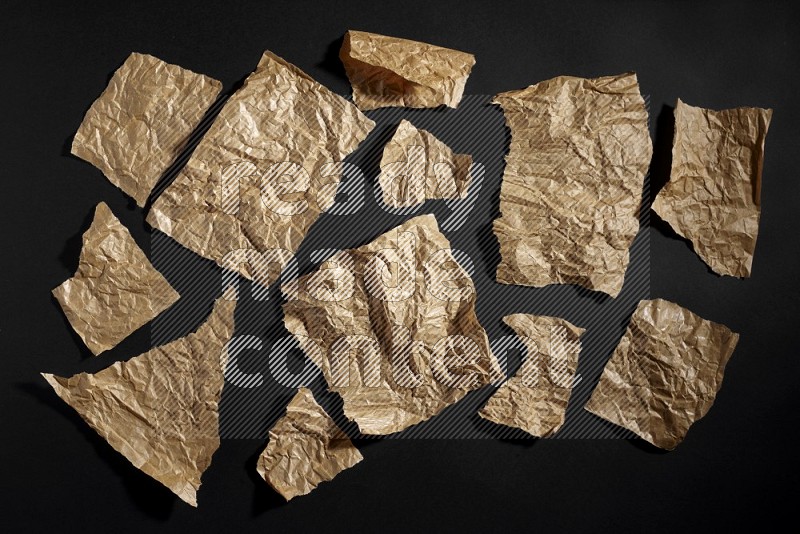 Crumpled craft paper on black background