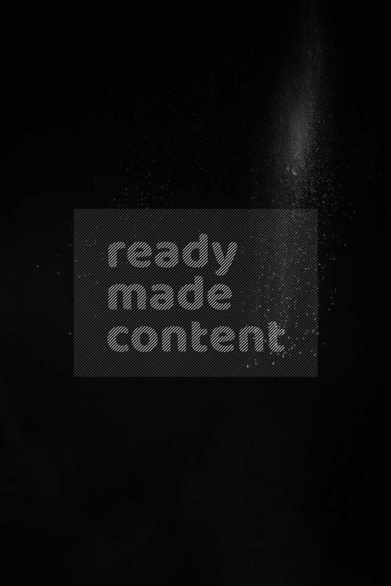 A side view of white powder explosion on black background