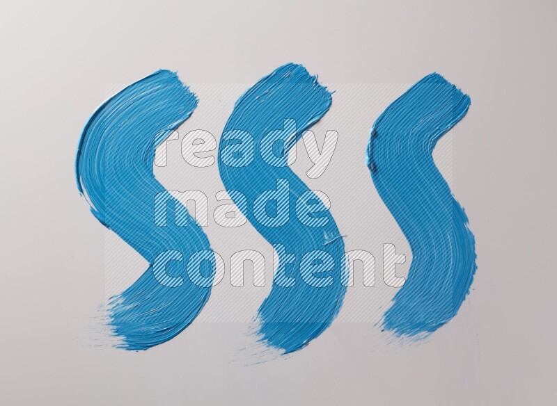 Multi blue curved brush strokes shaped into different shapes on a white background