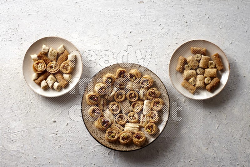 Oriental sweets in pottery plates in a light setup