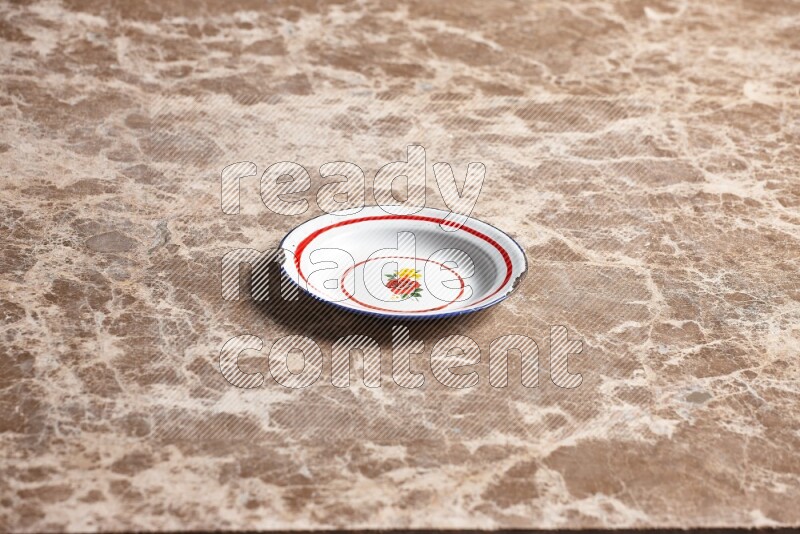 A vintage metal plate on beige marble background