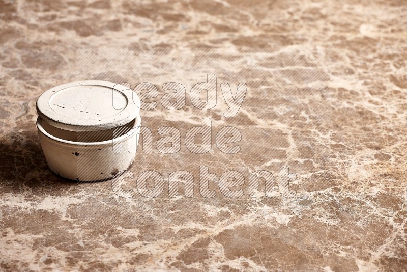 White Pottery Bowl on Beige Marble Flooring, 45 degrees