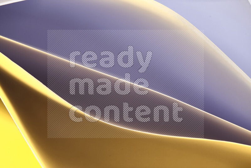 This image showcases an abstract paper art composition with paper curves in purple and gold gradients created by colored light
