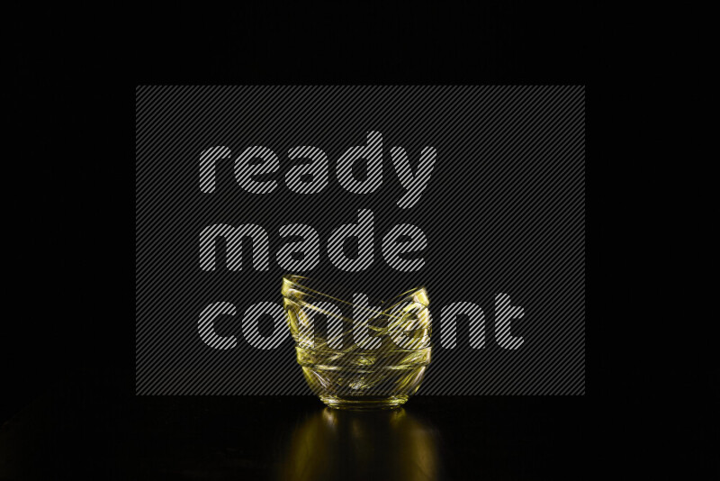 Glassware with rim light in yellow against black background