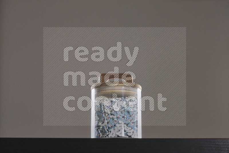 Buttons in a glass jar on black background