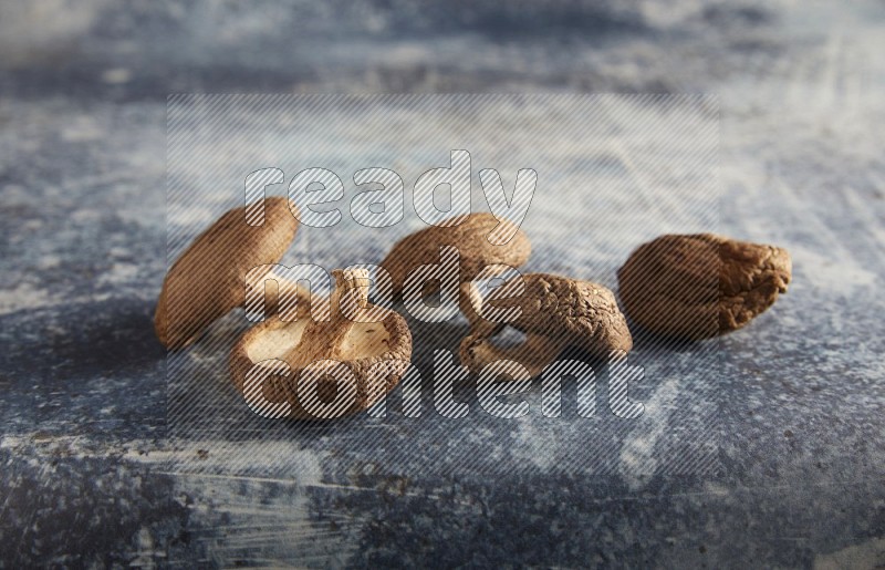 45 degre shiitake mushrooms on a textured rustic blue background