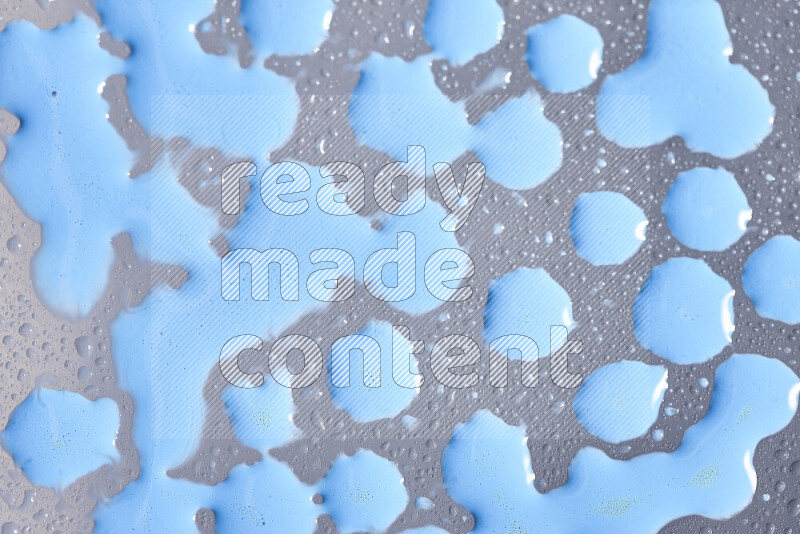 Close-ups of abstract blue paint droplets on the surface