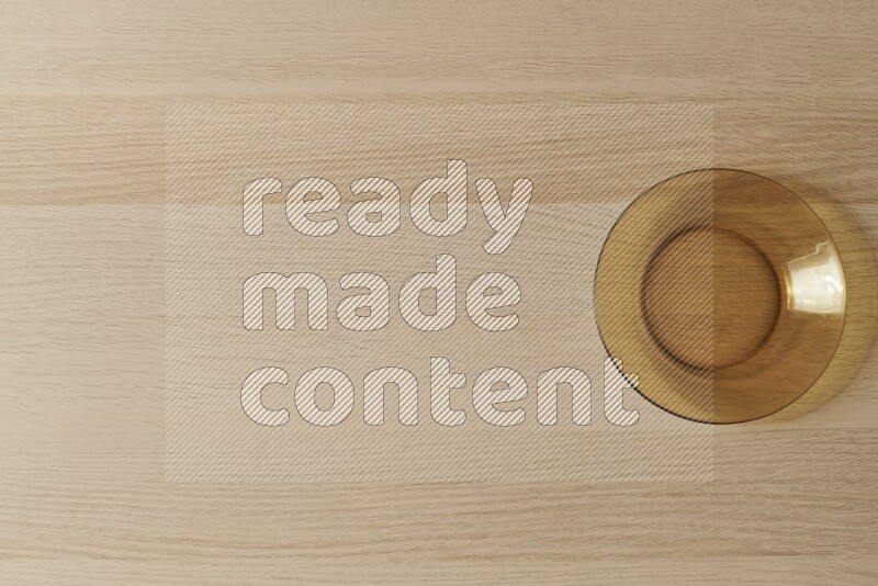 A circular glass plate on light wooden background