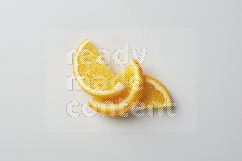 Three halves of an orange slices on white background