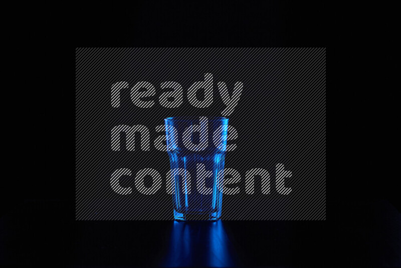 Glassware with rim light in blue against black background