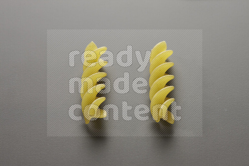 Fusilli pasta on grey background