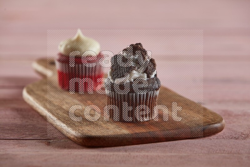 Chocolate mini cupcake topped with oreo on a wooden board
