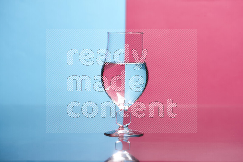 The image features a clear glassware filled with water, set against light blue and pink background