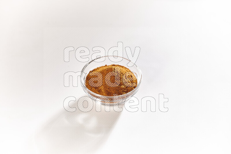 A glass bowl full of ground paprika powder on white background