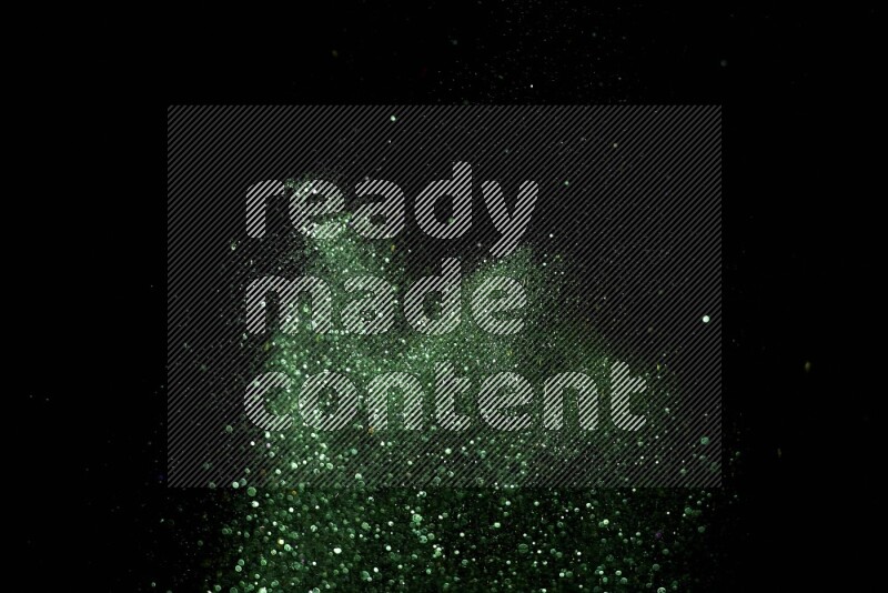 Green glitter powder isolated on black background