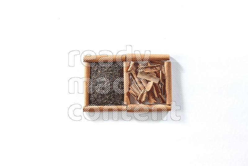 2 squares of cinnamon sticks full of black tea and cinnamon on white flooring