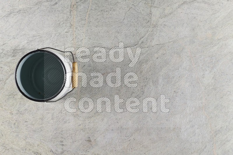 Top View Shot Of A Vintage Milk Can On Grey Marble Flooring