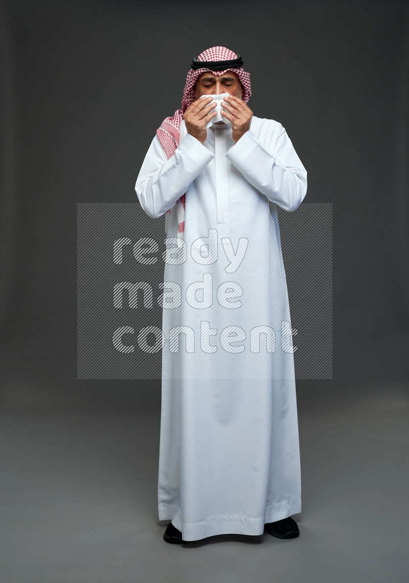 Saudi man with shomag Standing feeling sick on gray background