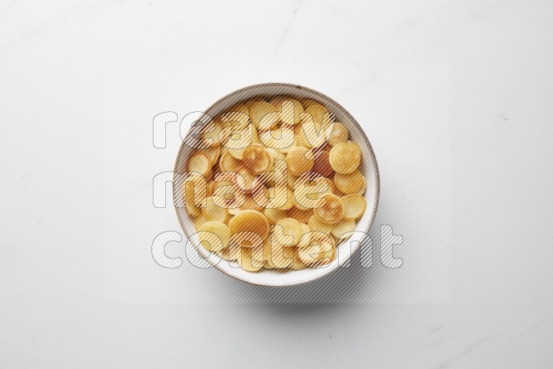 Top-view shot of plain cereal pancakes in a round bowl on white background