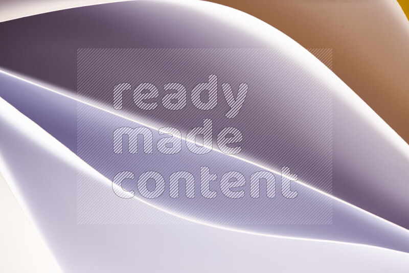 This image showcases an abstract paper art composition with paper curves in white and different warm gradients created by colored light