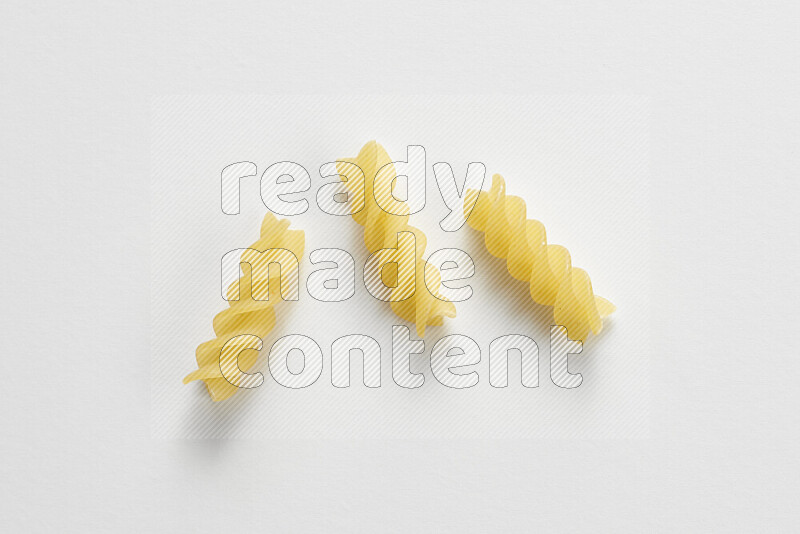 Fusilli pasta on white background
