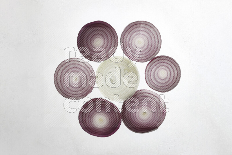 Onion slices on illuminated white background