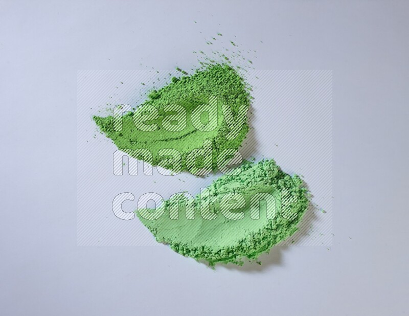 Green powder strokes on white background