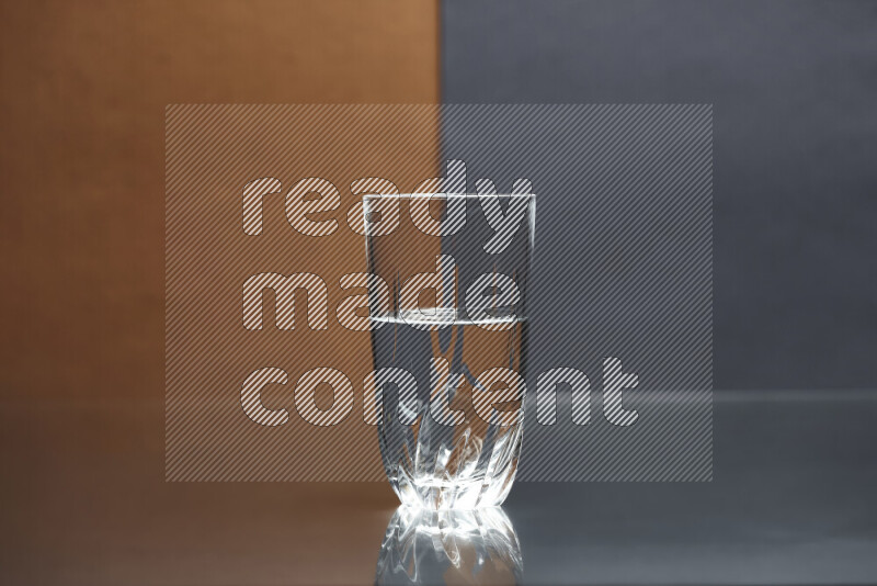 The image features a clear glassware filled with water, set against brown and dark blue background