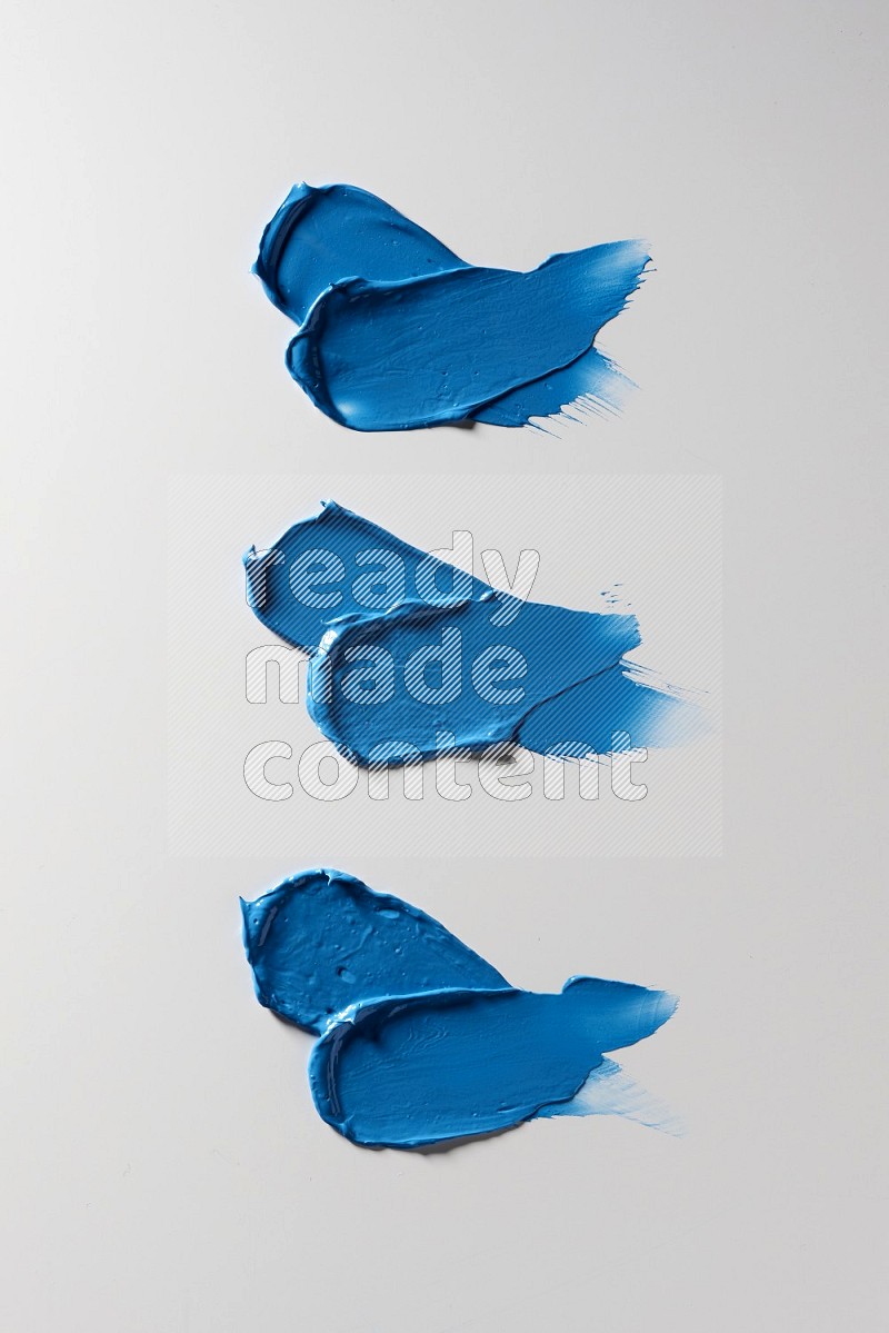 Blue painting knife strokes on white background