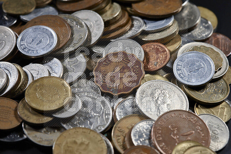 A close-ups of random old coins on black background