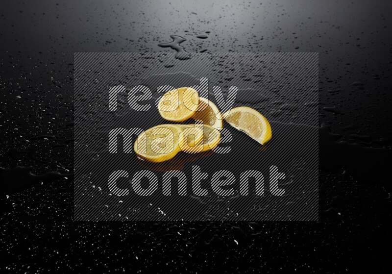Lemon slices with water drops, and droplets on black background