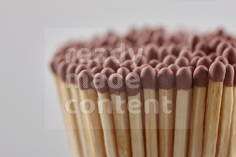 A close-up of a bundle of matches on grey background
