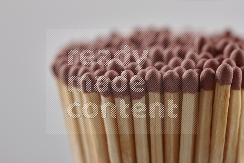 A close-up of a bundle of matches on grey background