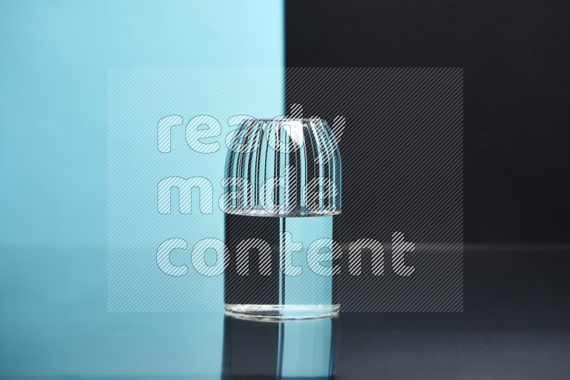 The image features a clear glassware filled with water, set against light blue and black background