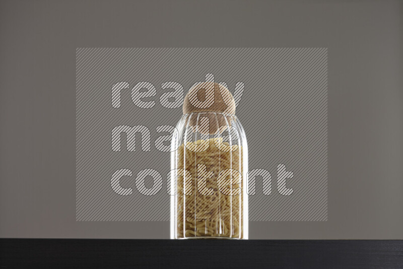 Snacks in a glass jar on black background