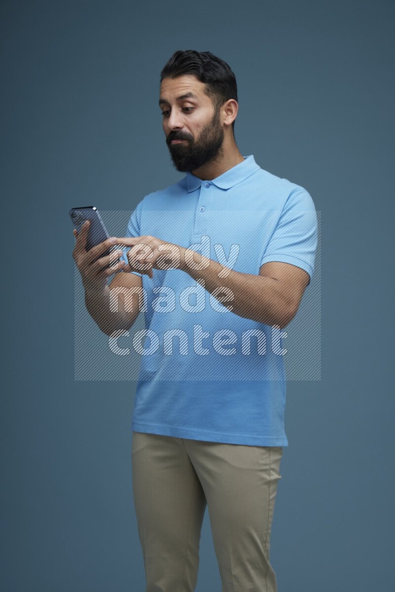A man Swiping in a blue background wearing a Blue shirt