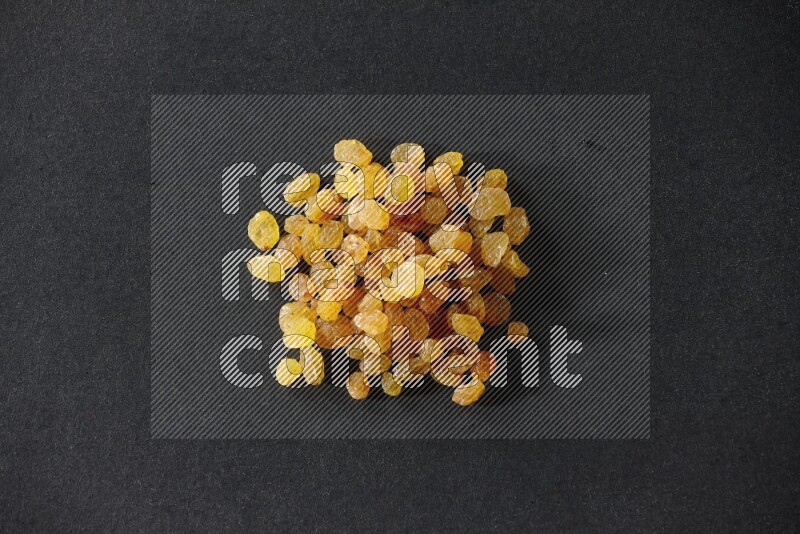 Yellow raisins isolated on a black background in different angles