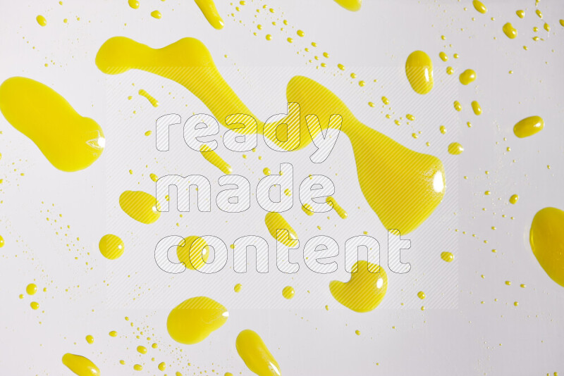 Close-ups of abstract yellow paint droplets on white background