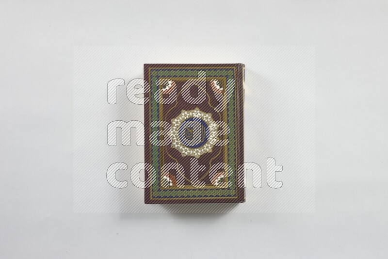 Quran with a prayer beads on white background