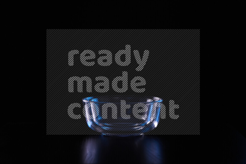 Glassware with rim light in blue and white against black background