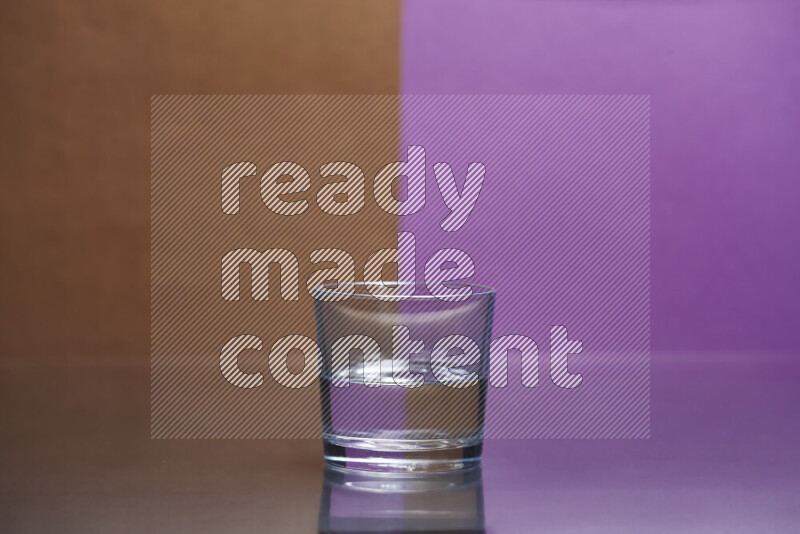 The image features a clear glassware filled with water, set against brown and purple background