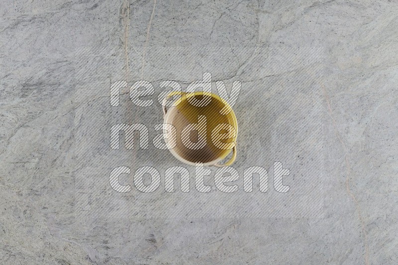 Top View Shot Of A Multicolored Pottery Bowl On Grey Marble Flooring