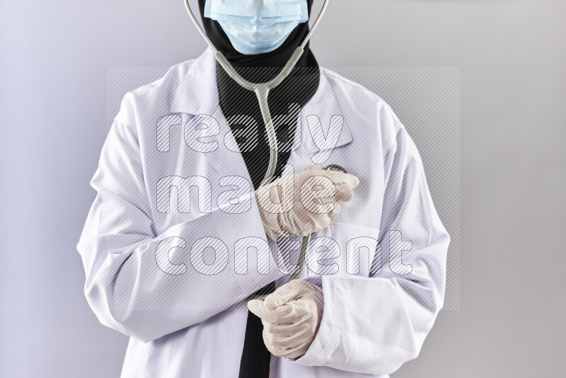 Female doctor wearing an abaya and medical attire in different positions