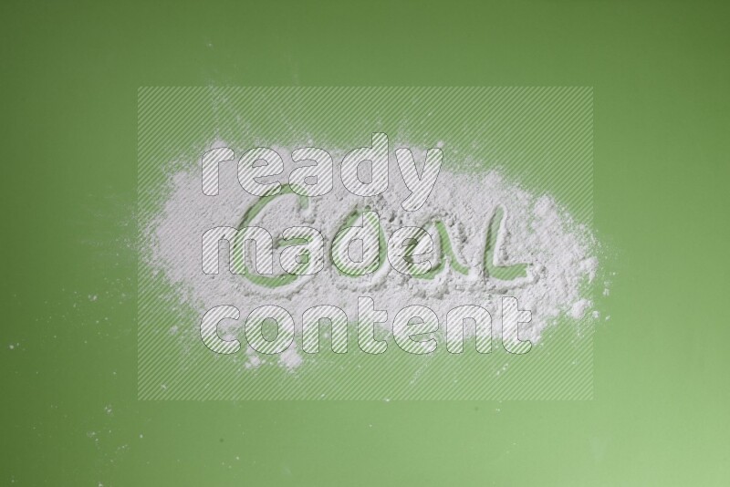 A word written with powder on green background