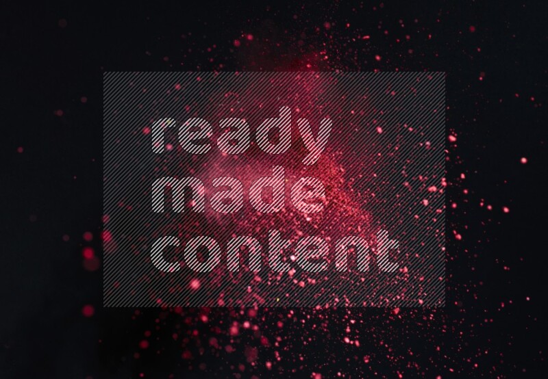 Red powder explosion on black background