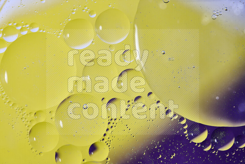 Close-ups of abstract oil bubbles on water surface in shades of purple and yellow