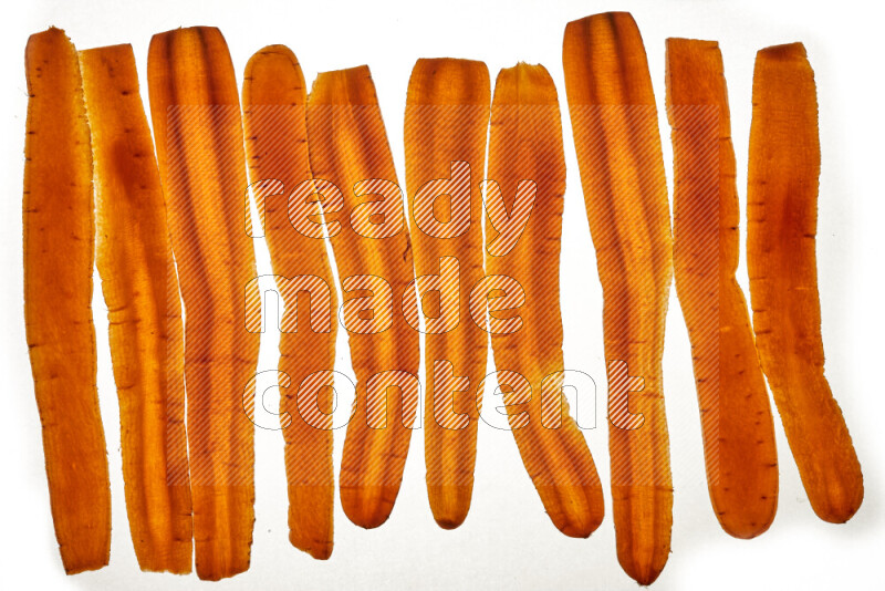 Carrots slices on illuminated white background